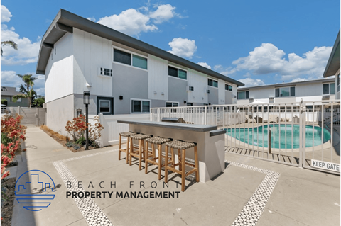 a patio with a bar and a pool in front of a building