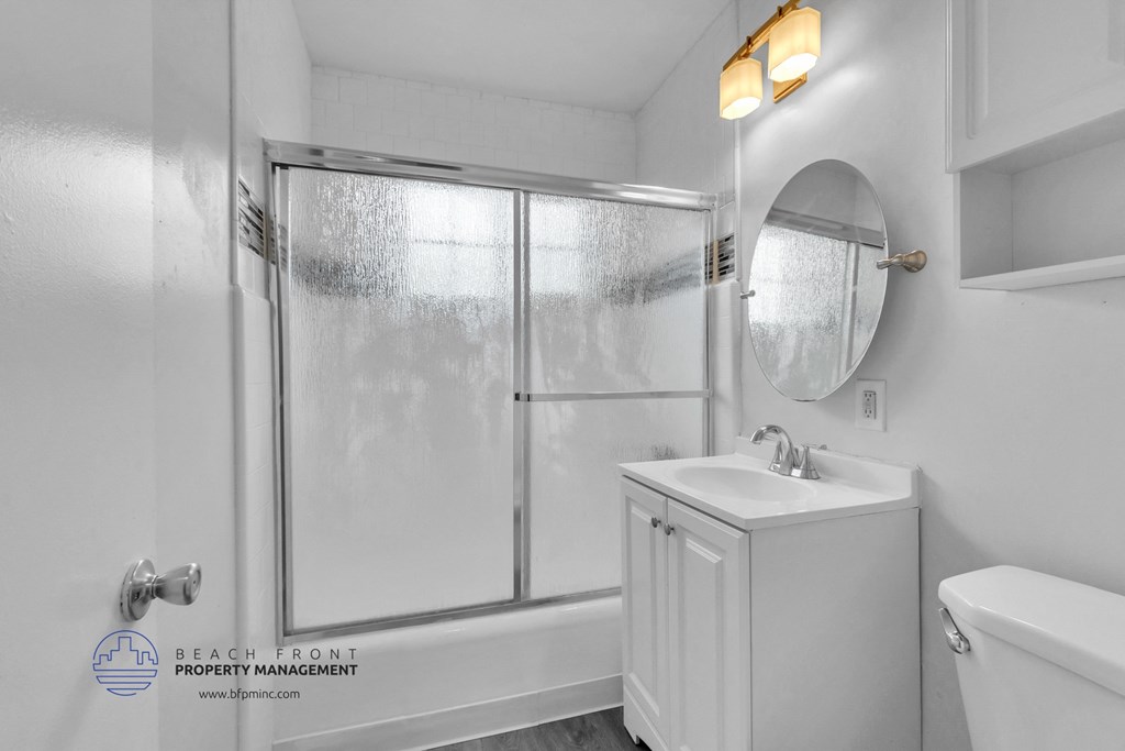 a bathroom with white fixtures and white walls