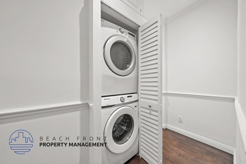 a white washer and dryer in a white laundry room