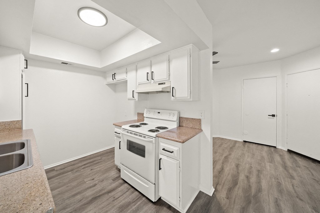 a kitchen with white appliances and white cabinets