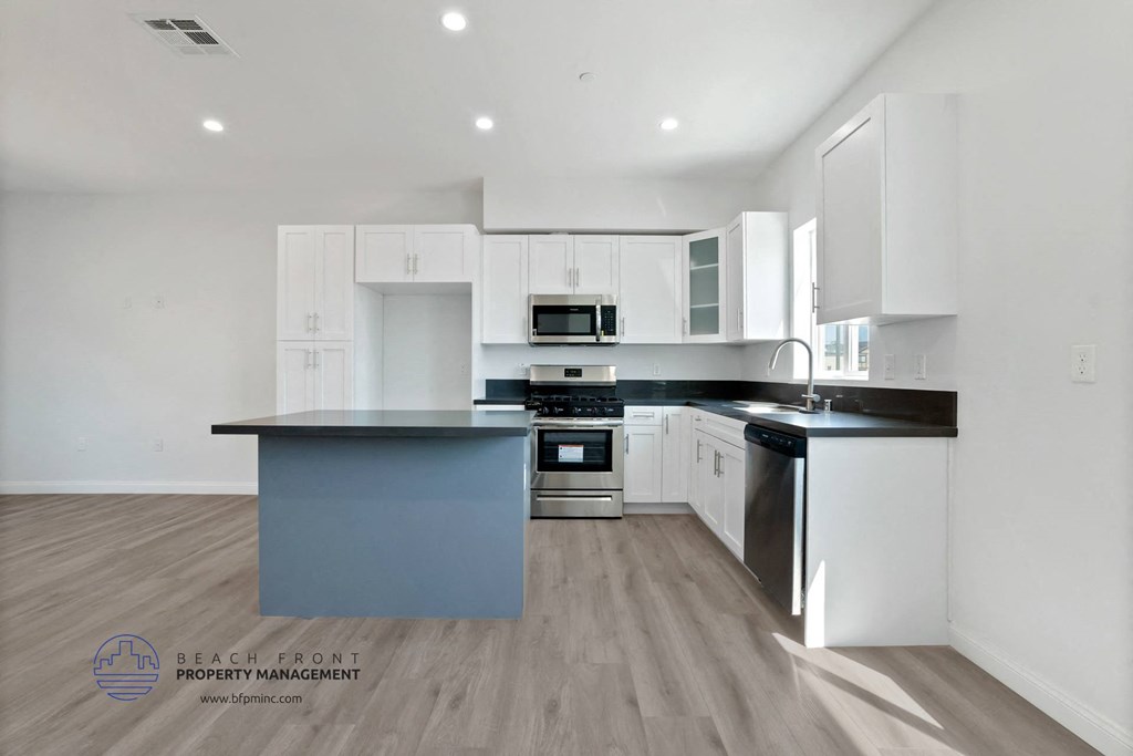 a kitchen with white cabinets and a blue counter top