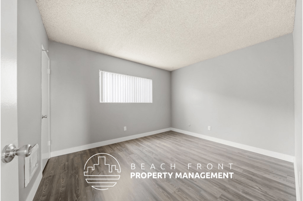 an empty room with a door and a window