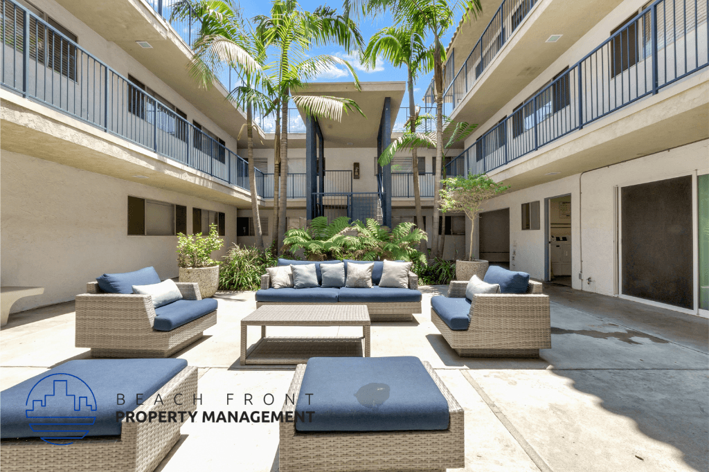 a patio area with couches and tables in a courtyard