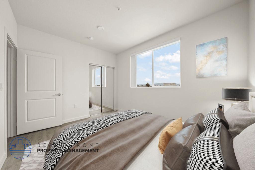 a bedroom with a large bed and a door to a bathroom