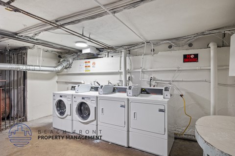 an image of a laundry room with four washing machines in it