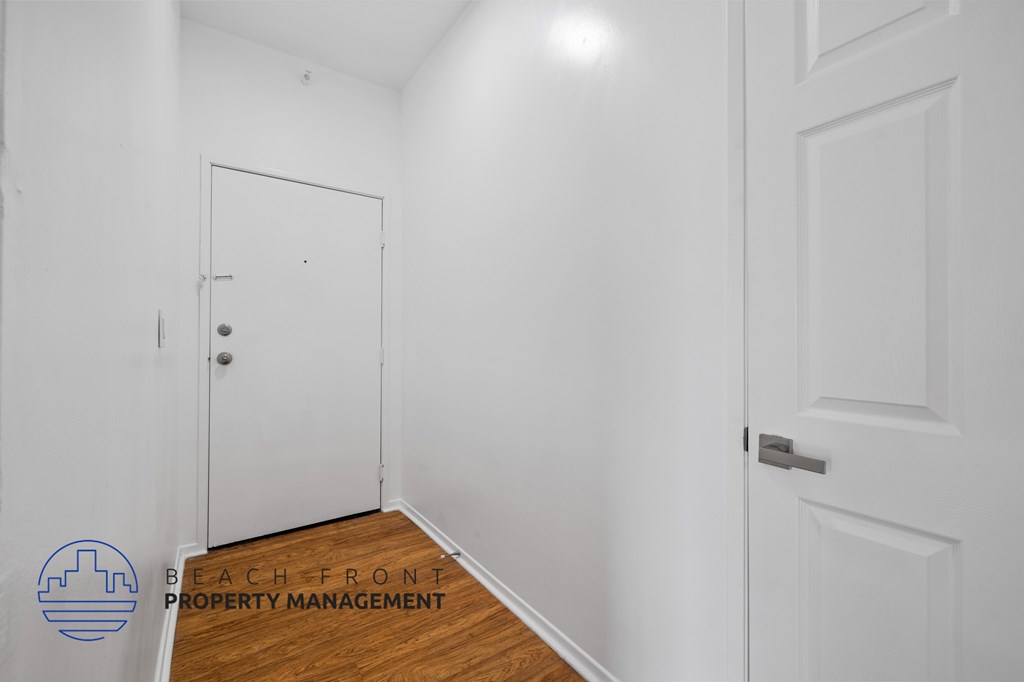 A white door is on the left and a white door with a handle is on the right.