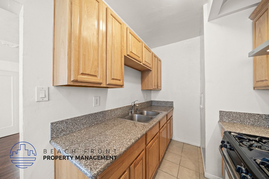 A kitchen with wooden cabinets and granite countertops.