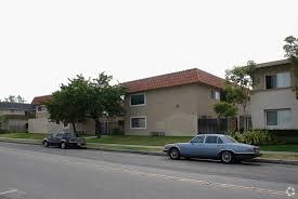 two cars parked on a street in front of houses
