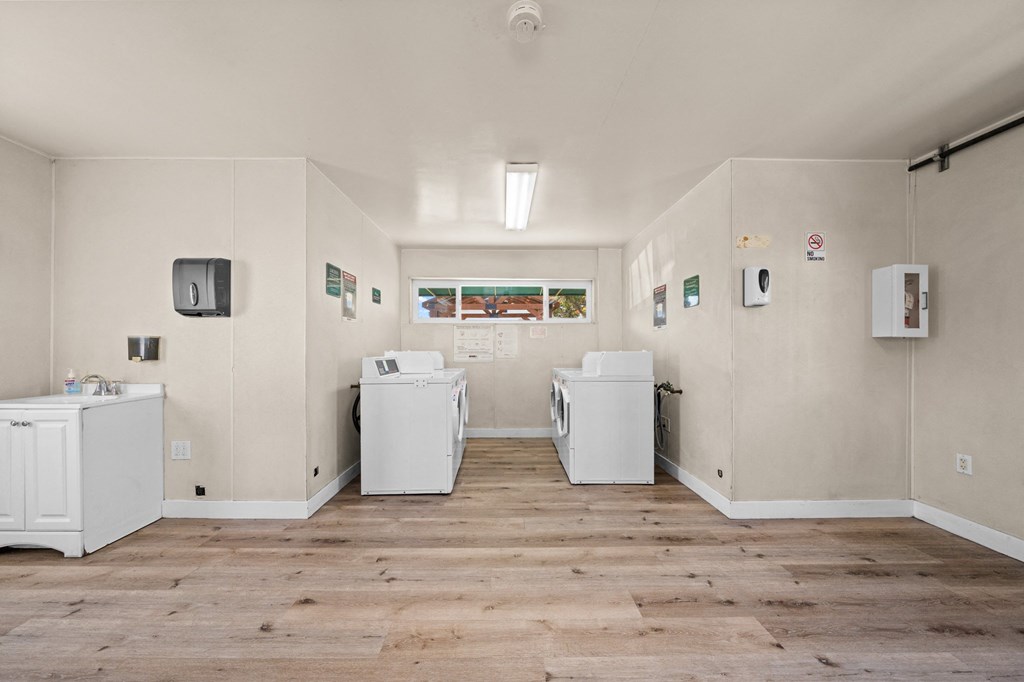 a room with two washers and two washing machines in it
