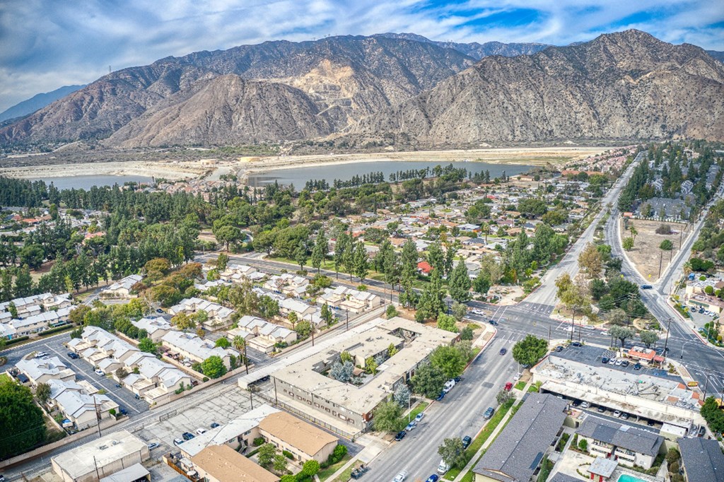 an aerial view of a city with mountains in the background