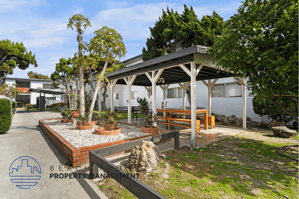 a picnic area in front of a building with trees