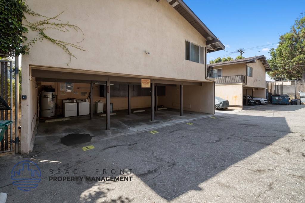 a garage in front of a building with a parking lot
