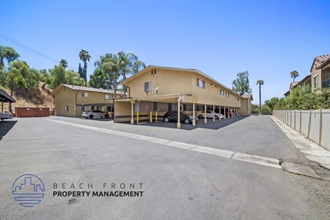 a parking lot in front of a building with cars parked