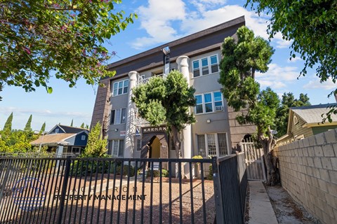 a house with a fence and a gate in front of it