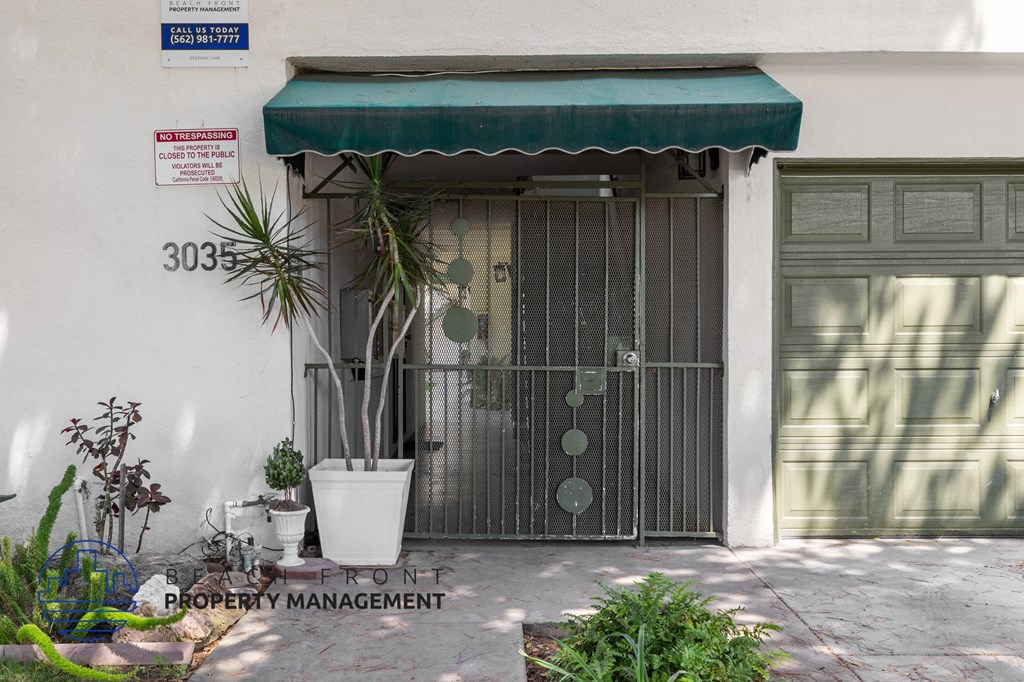 a garage door with a green awning in front of a building