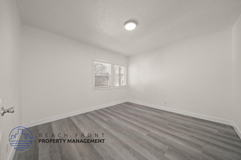 A room with a logo of Beach Front Property Management on the bottom left.