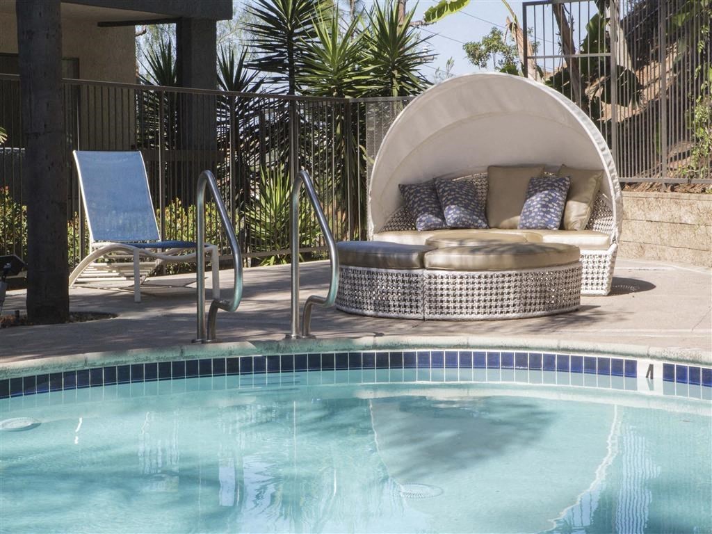 a round lounge chair next to a pool