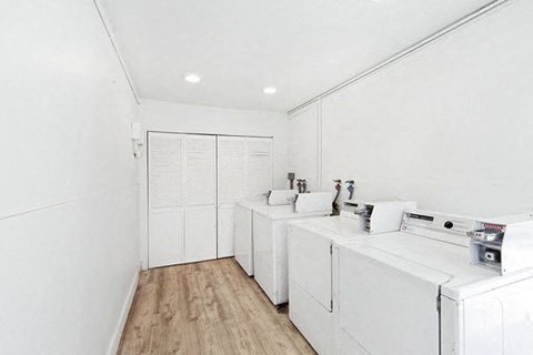A white bathroom with a sink and a toilet.