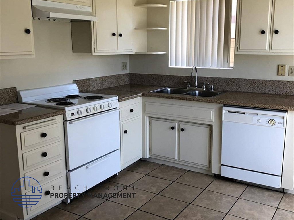 a kitchen with white appliances and white cabinets