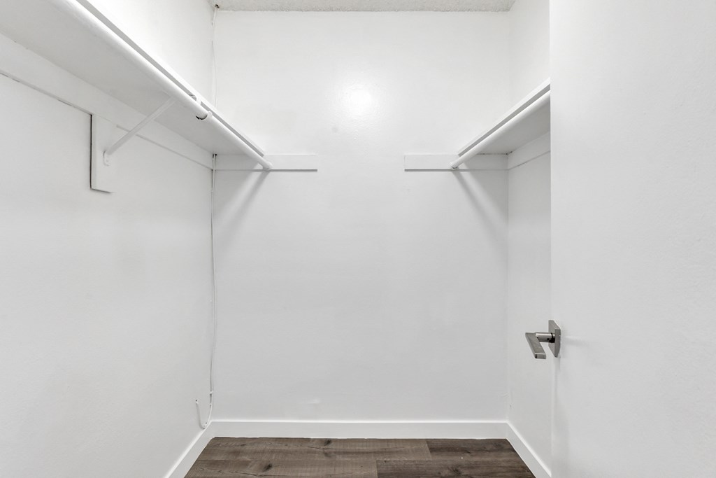 an empty room with white walls and a white door