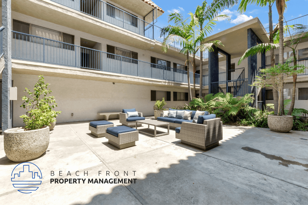 a patio with couches and chairs in front of a building