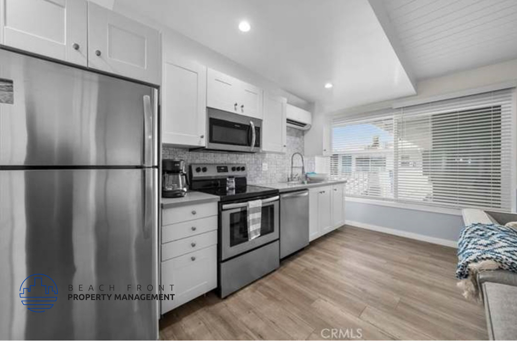 a kitchen with stainless steel appliances and white cabinets