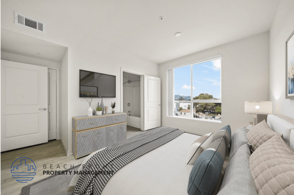 a white bedroom with a large bed and a large window