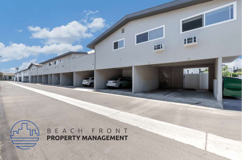 a beach front property management building with cars parked outside