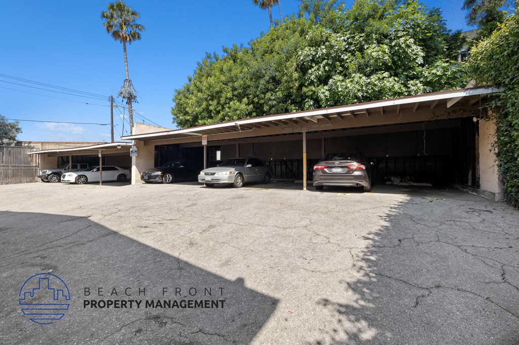 a parking lot with cars parked in front of a building