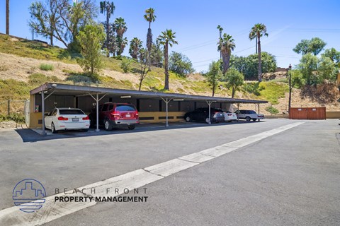 a parking lot with cars parked in front of a building