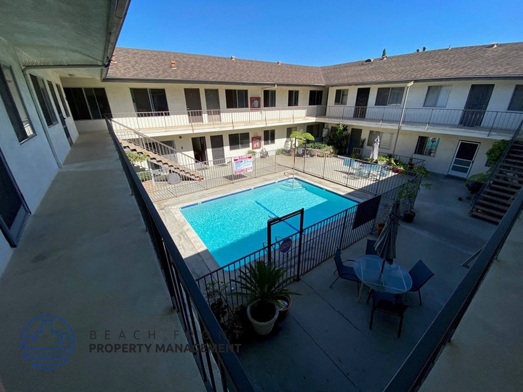 a view of the pool from the balcony of an apartment building