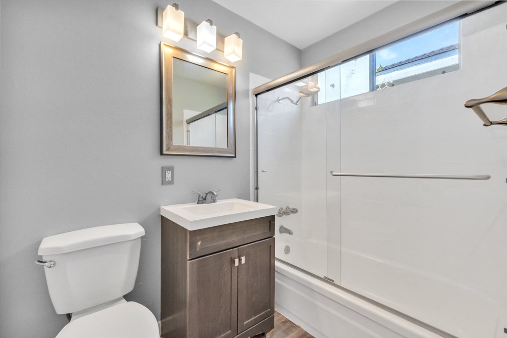 an empty bathroom with a toilet sink and shower