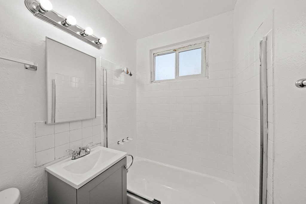 an empty bathroom with a sink and a shower