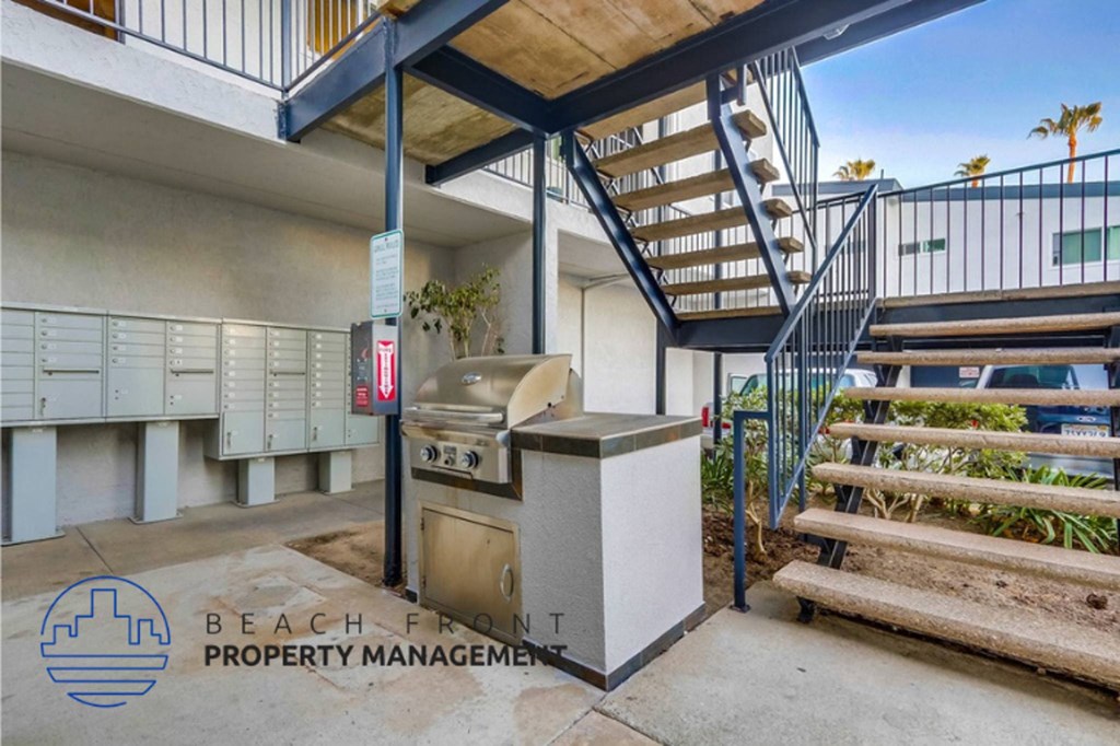a building with stairs and a grill in front of a grill