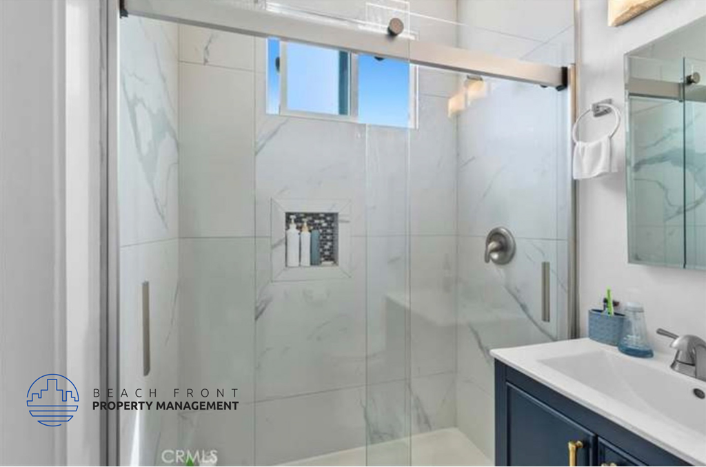 a bathroom with a shower and a sink and a mirror