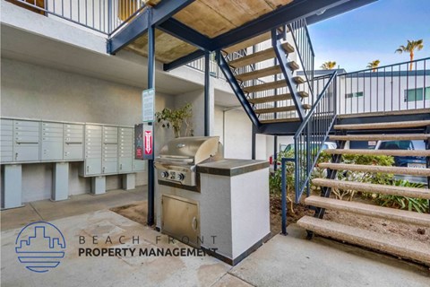 a building with stairs and a grill in front of a grill