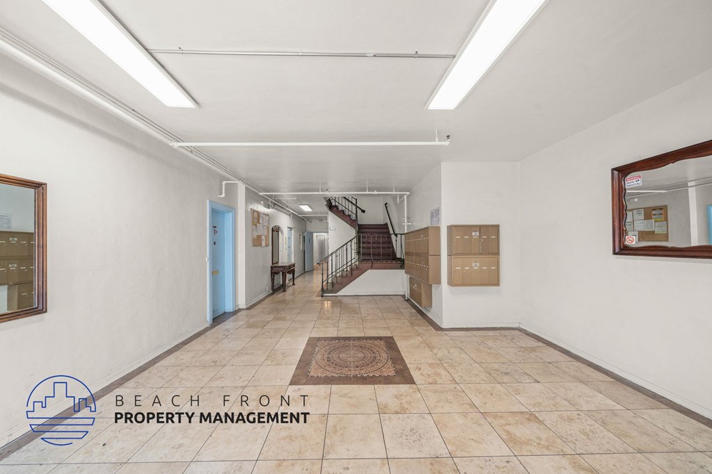 A hallway with a logo for Beach Front Property Management.