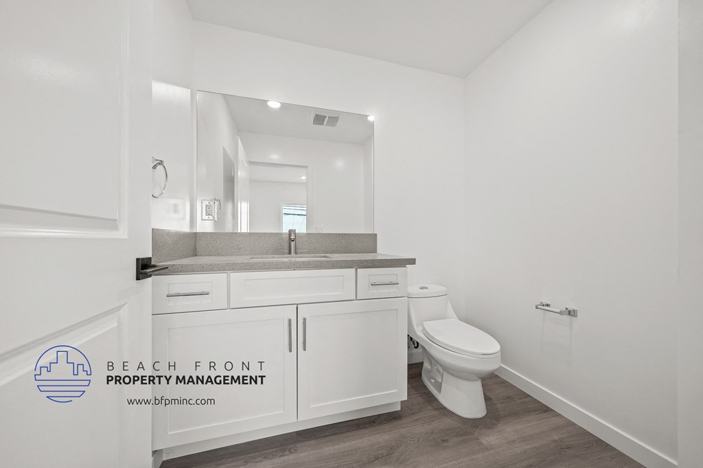 a bathroom with a toilet and a sink and a mirror