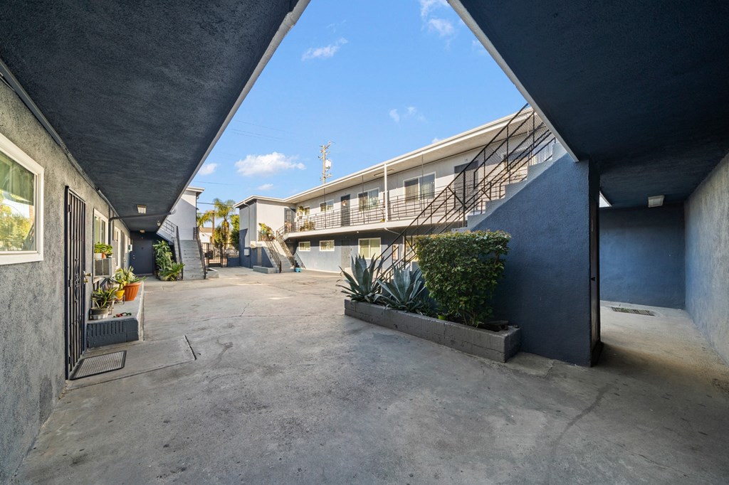 the parking lot of a building with a blue sky in the background