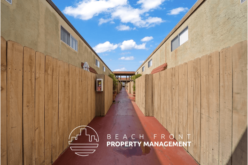 a corridor with wooden walls and a red walkway with a blue sky