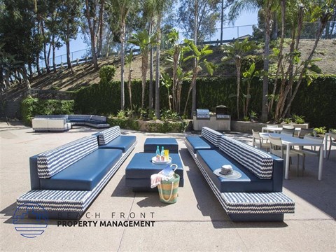 a lounge area with blue couches and tables