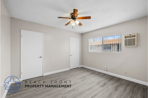 a bedroom with a ceiling fan and a door to a closet