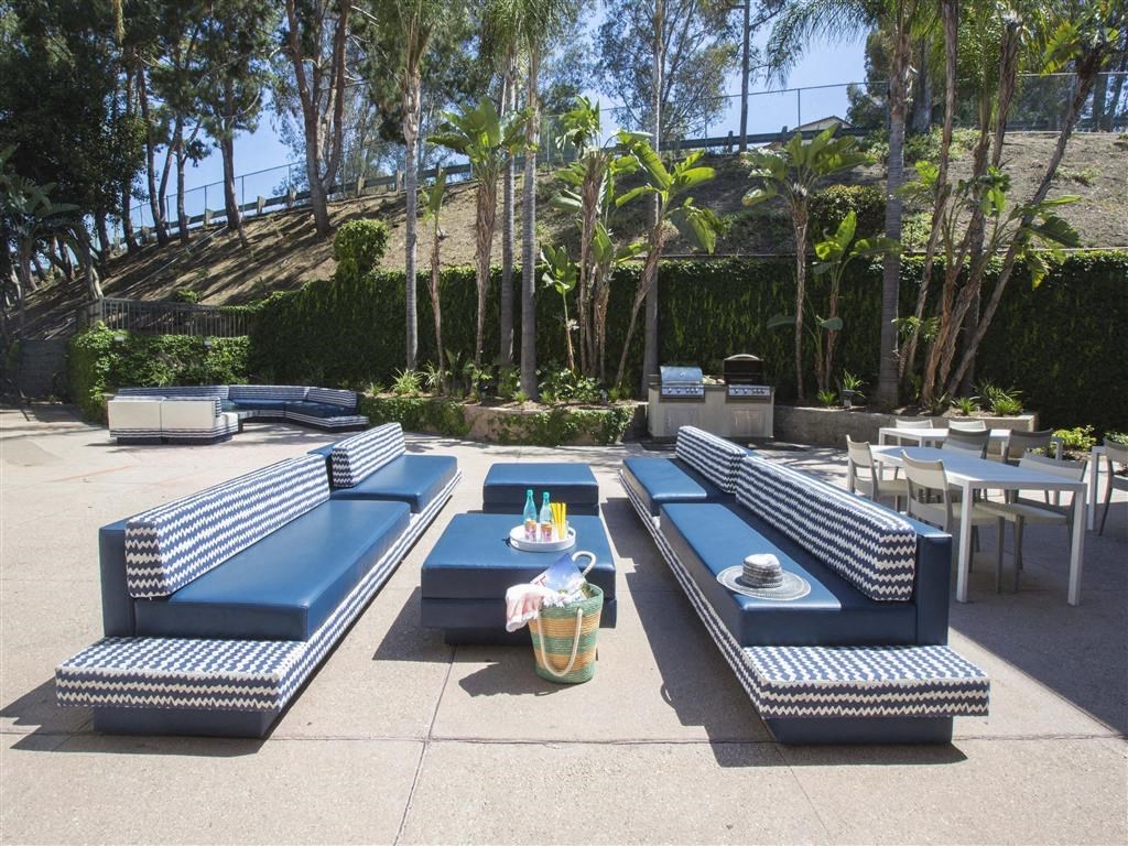 a lounge area with blue couches and tables
