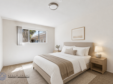 A well-lit bedroom with a large bed and a window.