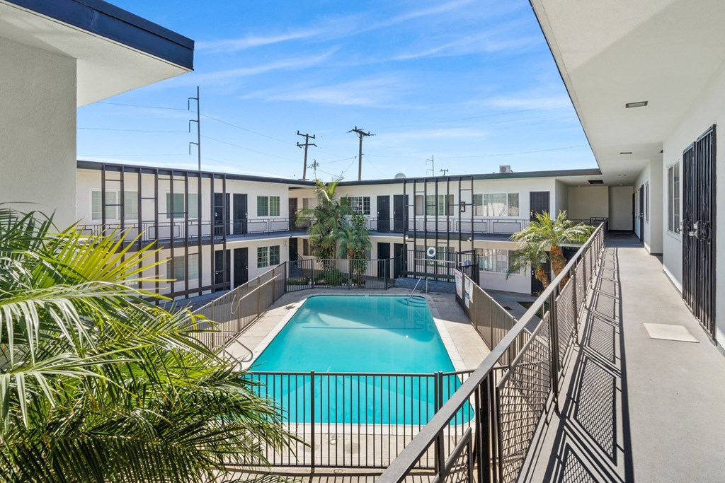 a view of a swimming pool from a balcony of a building