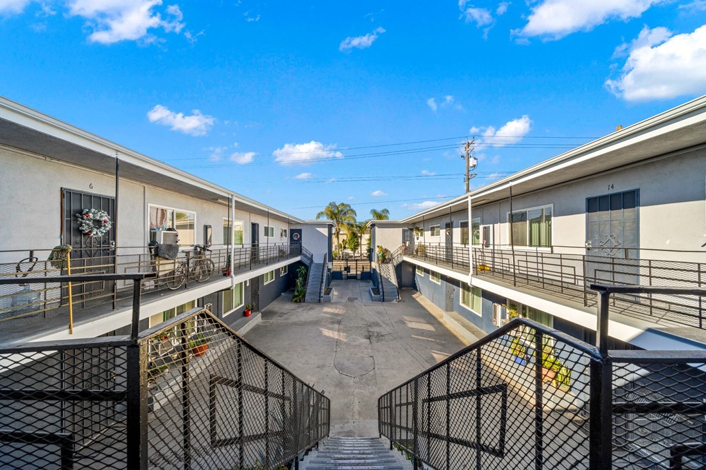 the yards are fenced in and have balconies and stairs
