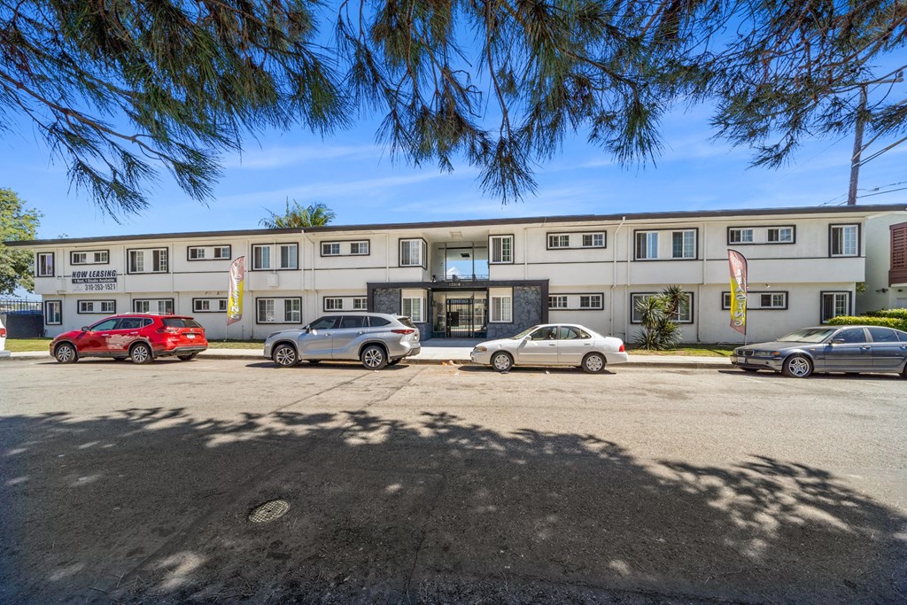 a large white building with cars parked in front of it