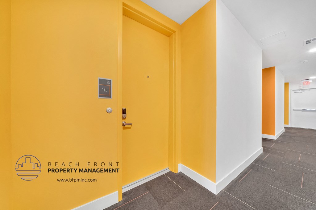 a hallway with yellow walls and white walls and a yellow door