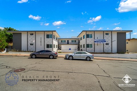 a building with two cars parked in front of it