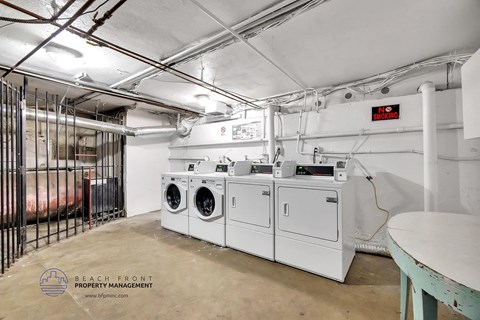 A laundry room with washers and dryers.